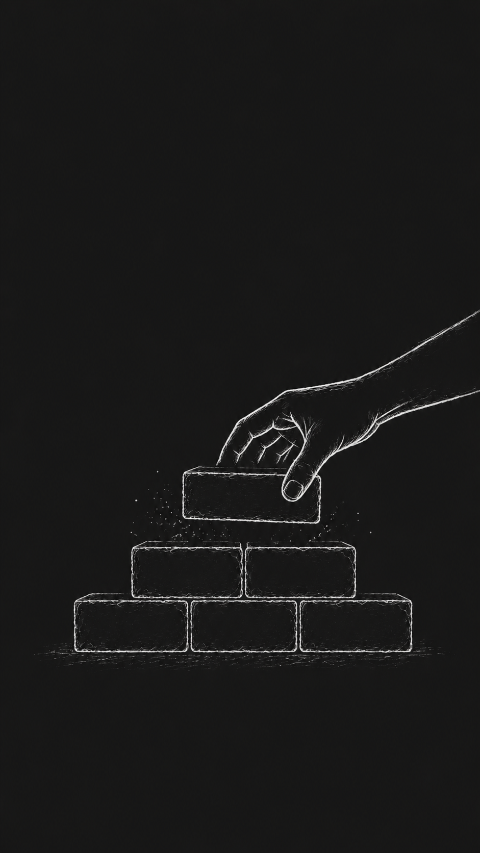 A hand placing a brick on a small wall — building yourself, brick by brick, daily.